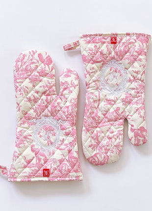 Pair of pink toile de jouy patterned ovenmitts with royal emblem embroidery 