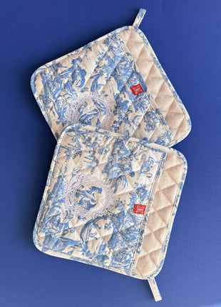 Pair of blue toile de jouy patterned pot holders with royal emblem embroidery