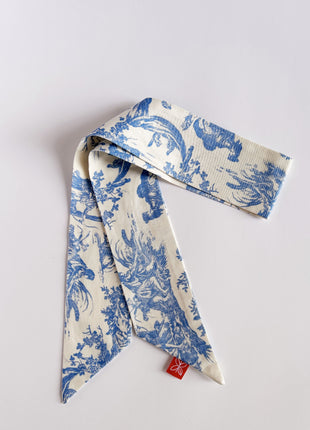 Blue toile de jouy patterned twilly, headband, and tie.
