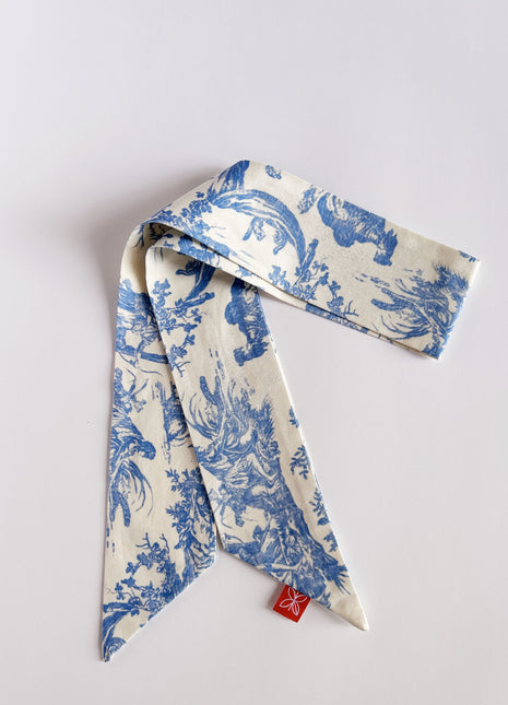 Blue toile de jouy patterned twilly, headband, and tie.