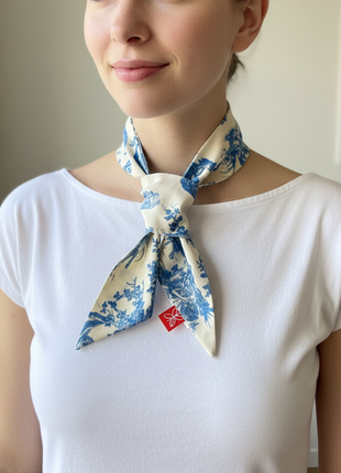 Model wearing a blue toile de jouy patterned twilly 