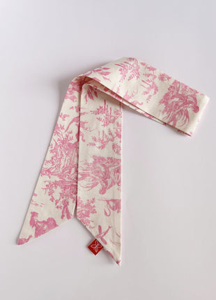 Pink toile de jouy patterned twilly, headband, and tie.