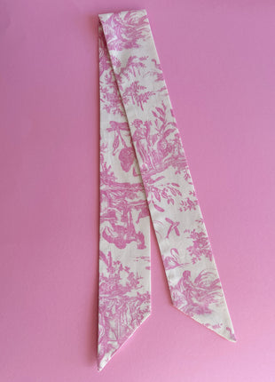 Pink toile de jouy patterned twilly, headband, and tie.