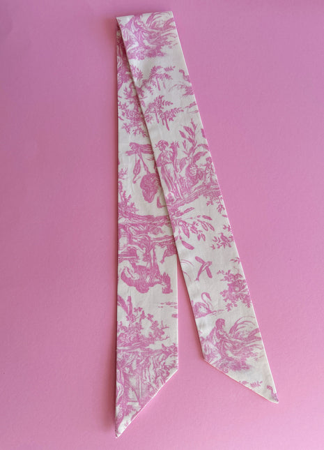 Pink toile de jouy patterned twilly, headband, and tie.